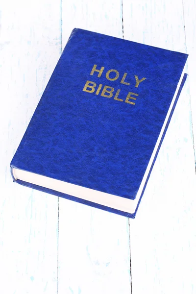 Bible on blue wooden table close-up