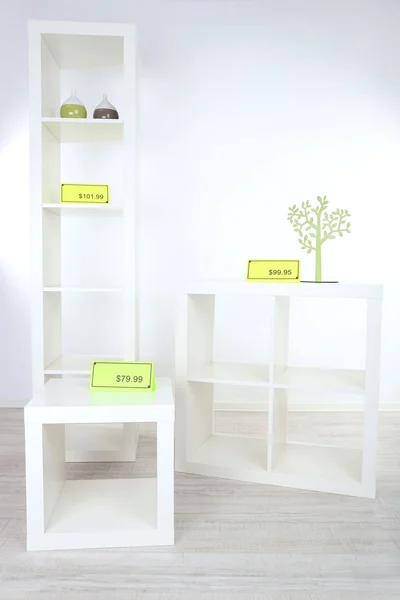 New white shelves with prices on light background