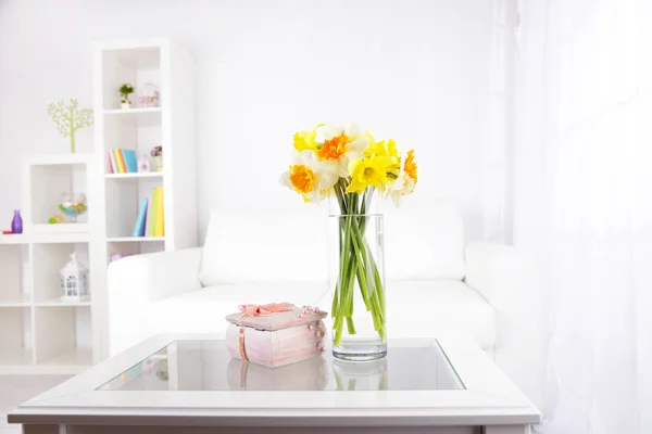 Beautiful spring flowers in vase on home interior background