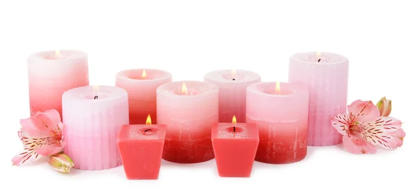 Beautiful candles with flowers isolated on white