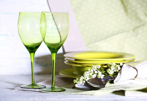 Green table settings, on table, on light background