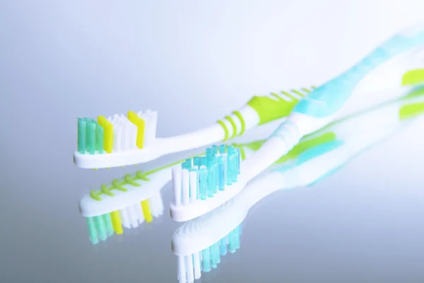 Toothbrushes on light grey background