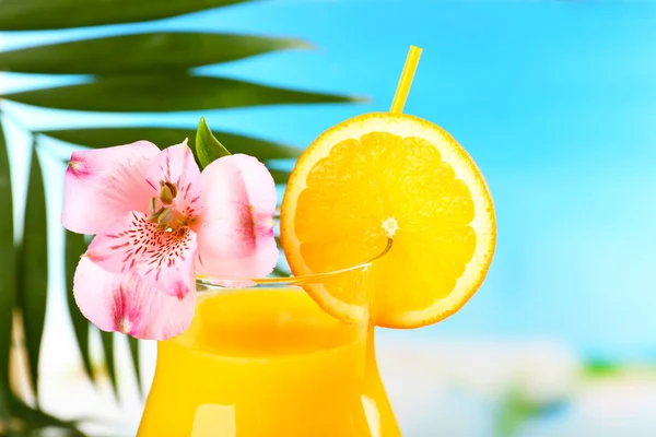 Refreshing orange cocktail on beach table