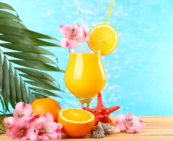 Refreshing orange cocktail on beach table