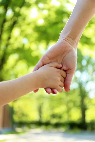 Mom and daughter hands, outdoors