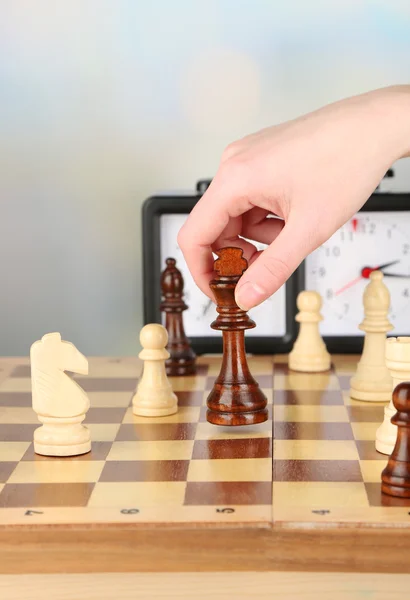 Woman playing chess, close up