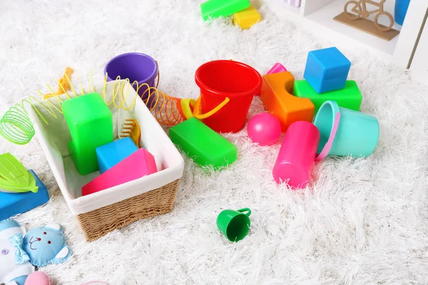 Colorful toys on fluffy carpet in children room