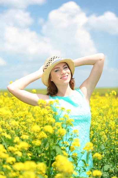 Beautiful young woman in flower field