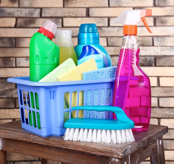 Cleaning products on shelf on bricks wall background