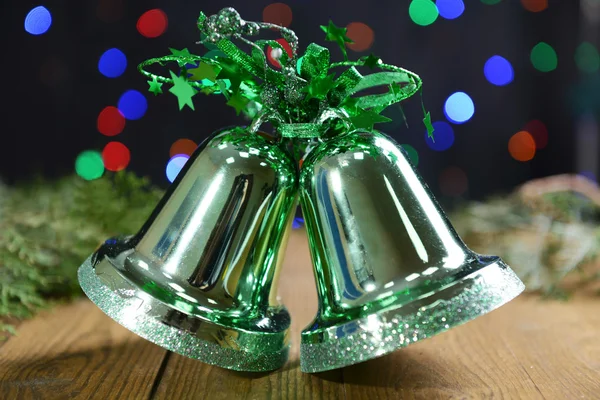 Christmas bells on table on bright background