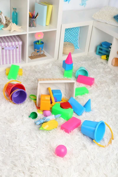 Colorful toys on fluffy carpet in children room