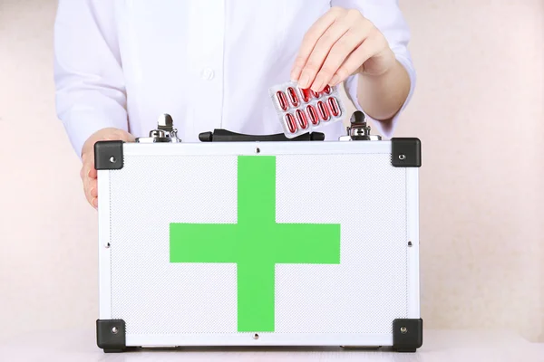 Nurse holding first aid kit