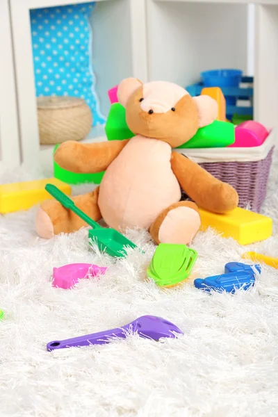 Colorful toys on fluffy carpet in children room