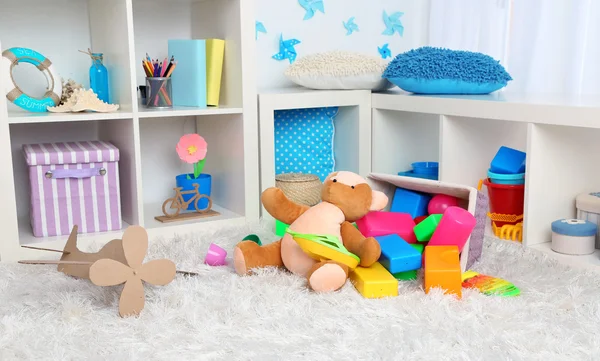 Colorful toys on fluffy carpet in children room