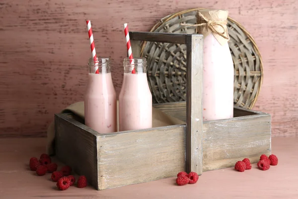 Bottles of tasty raspberry smoothie drinks