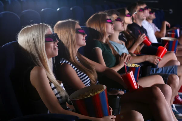 Young people watching movie in cinema