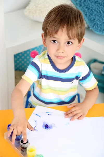 Boy painting in room