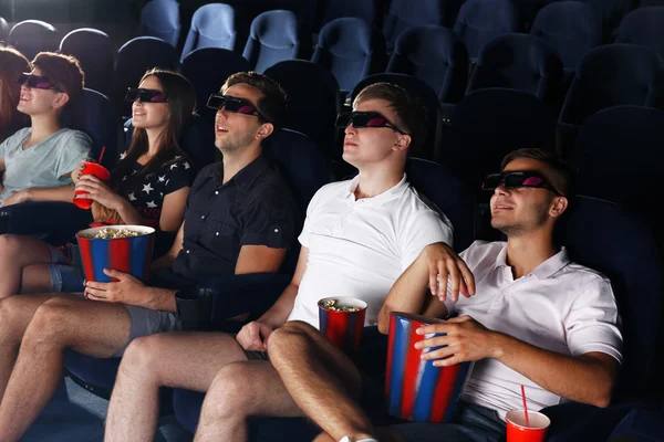 Young people watching movie in cinema