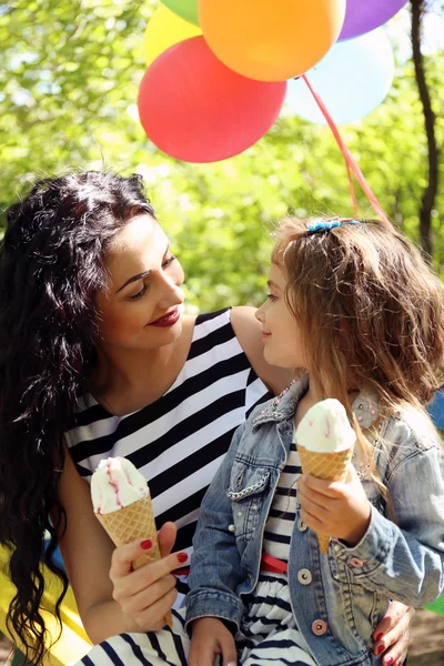 Happy mom and daughter. Walk in the green park