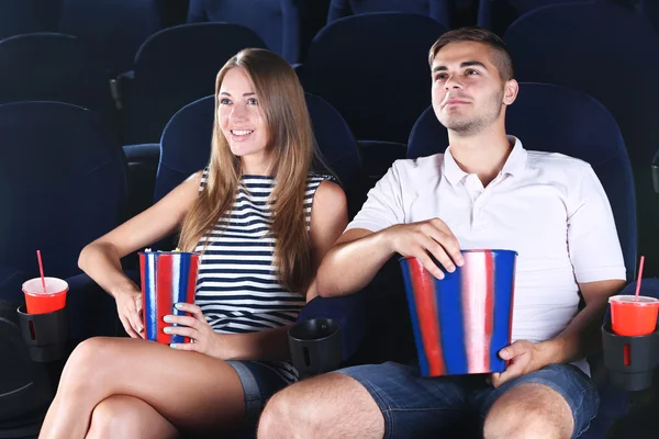 Young couple watching movie in cinema