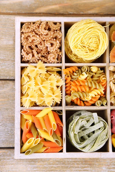 Colorful pasta in wooden box