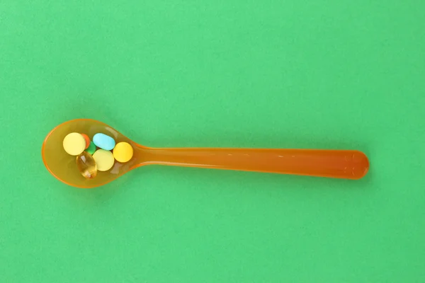Plastic spoons with color pills
