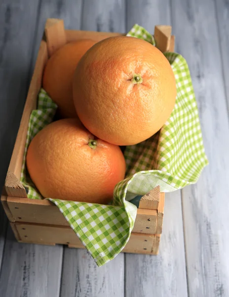 Ripe grapefruits in wooden box