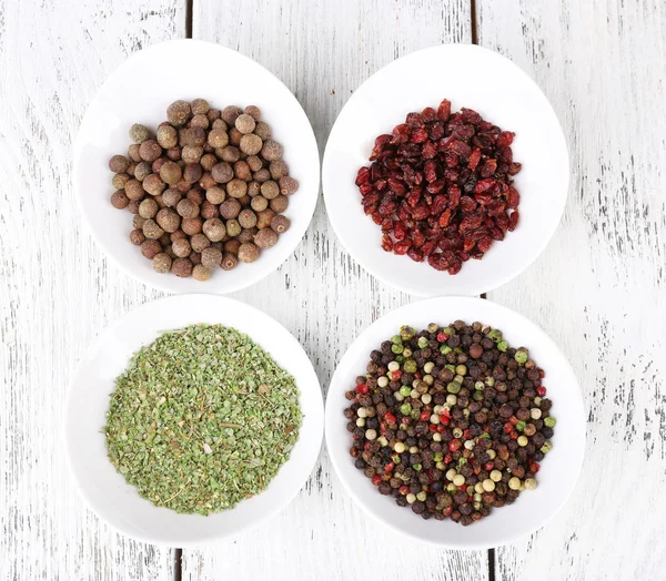 Spice in round bowls on wooden background