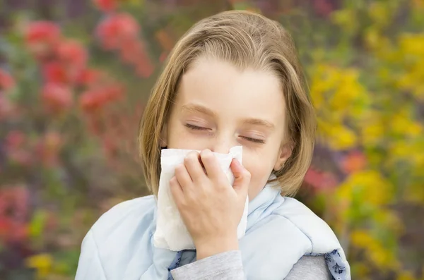 Little girl blowing her nose