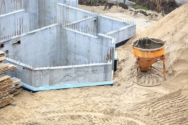 Construction building site pouring concrete in form sand