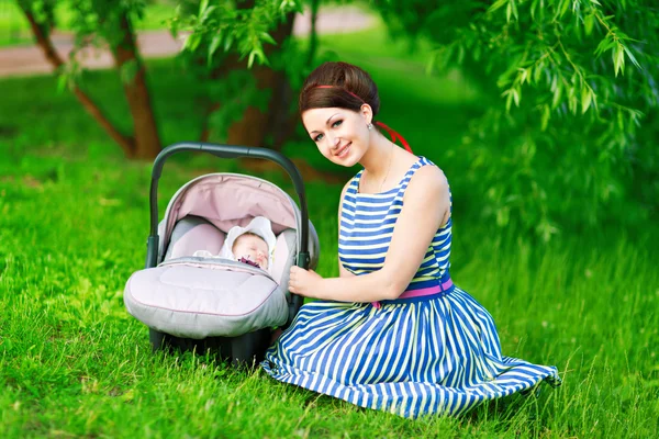 Young mother and newborn in the park