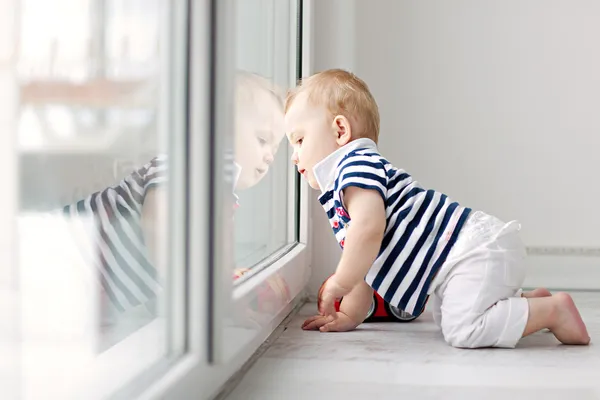 Little boy looking out the window