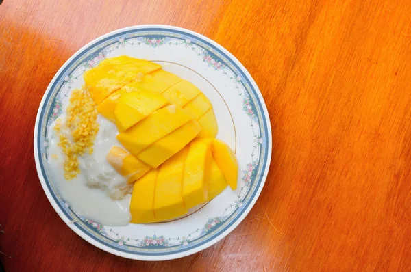 Thai style tropical dessert, glutinous rice eat with mangoes