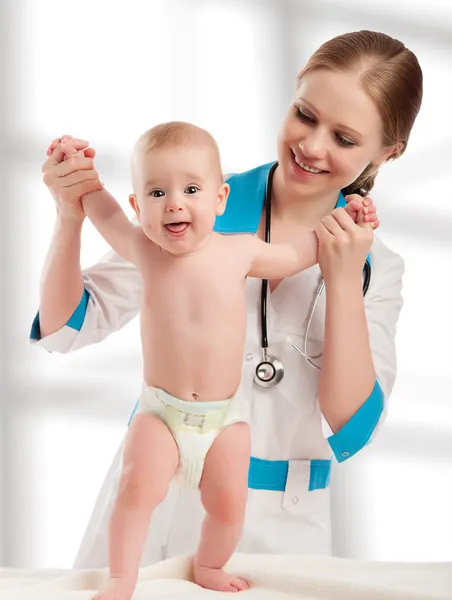 Pediatrician woman doctor holding baby