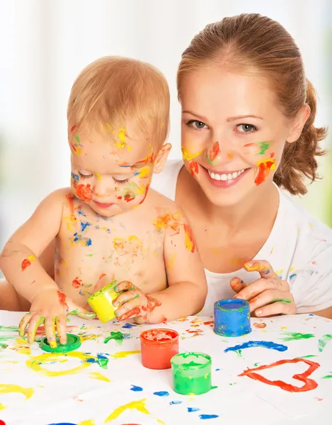 Mother and baby paint colors hands dirty