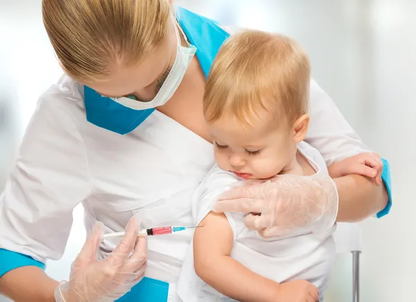 Doctor does injection child vaccination baby