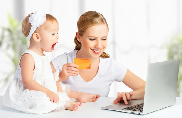 Mother and baby with a laptop and credit card