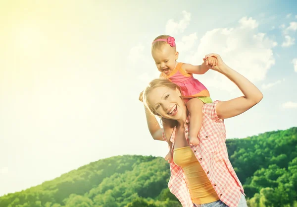 Happy family. mother and daughter baby girl playing on nature