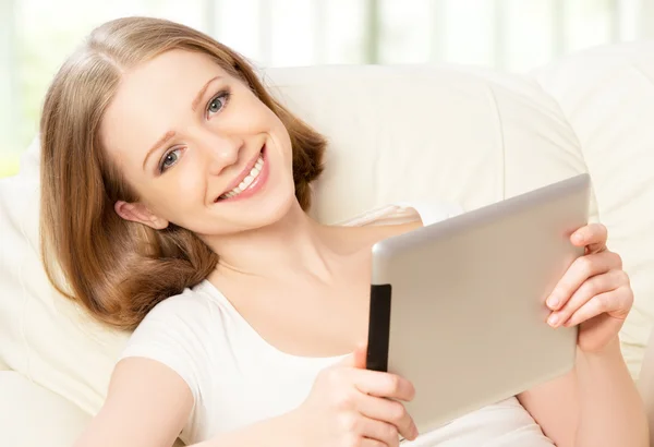 Happy woman with tablet pc at home