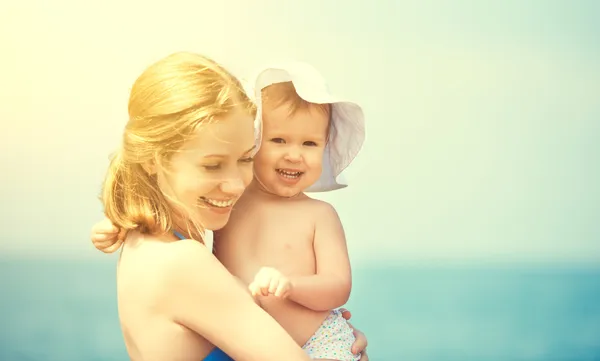 Happy family on the beach. mother and baby daughter