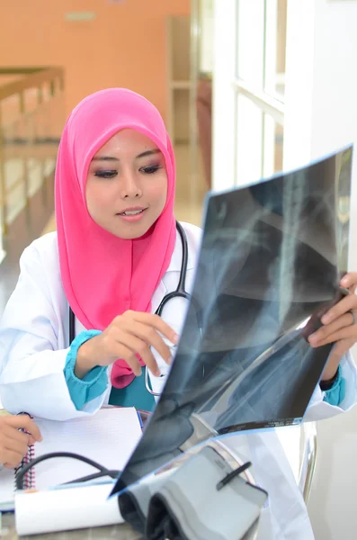 Confident Muslim doctor make analysis x-ray