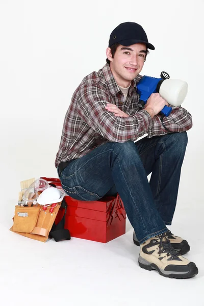 Tradesman posing for the camera with his tools