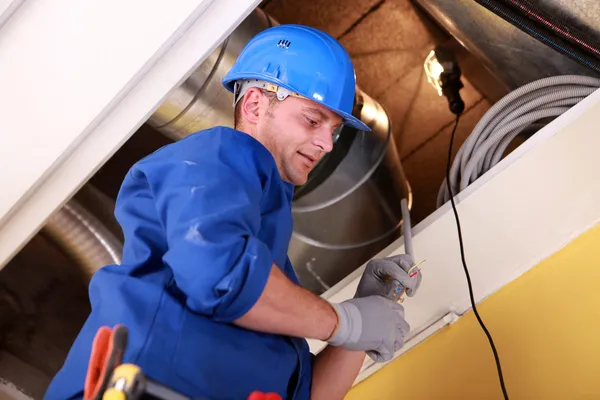 Men examining ventilation system