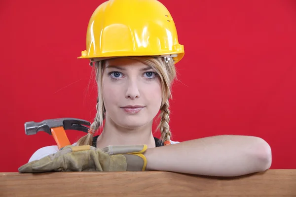 Woman in a hard hat holding a hammer