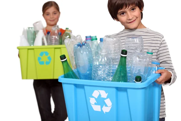 Children recycling plastic bottles