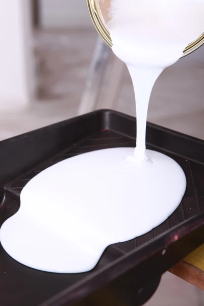 Pouring paint into a tray