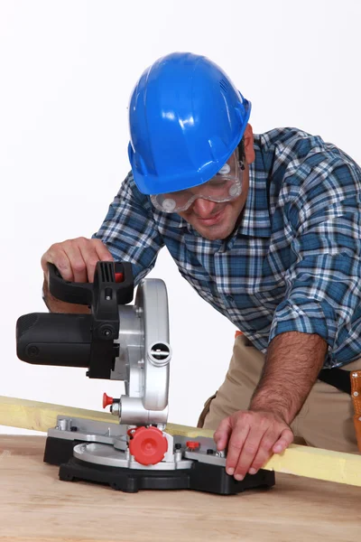 Carpenter using saw mounted to work surface