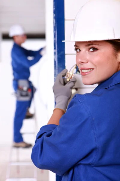 Female electrician installing a power point