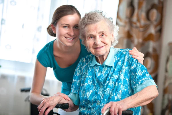 Senior woman with home caregiver