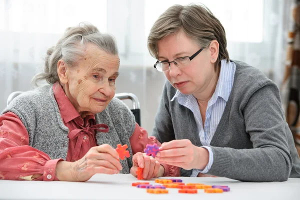 Senior woman with her elder care nurse